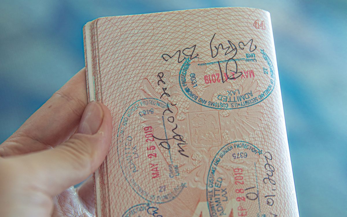 An open passport filled with entry and exit stamps